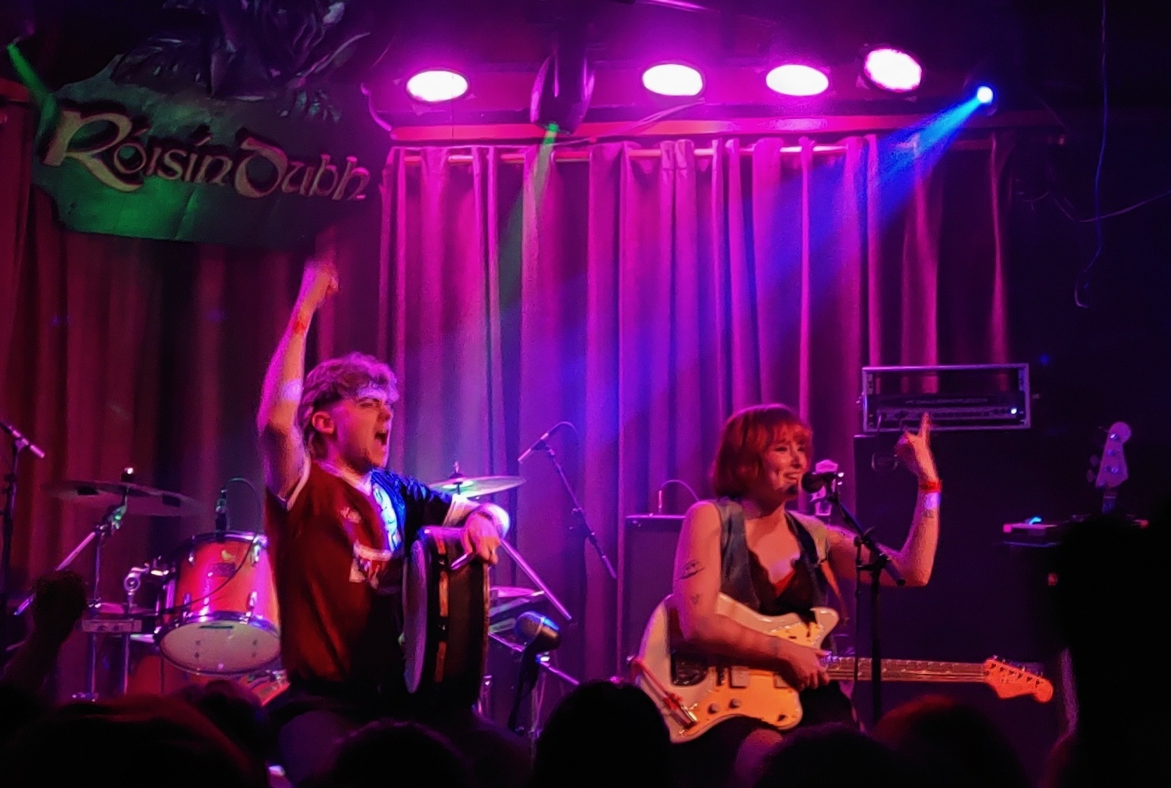 NewDad members Fiachra Parslow and Julie Dawson onstage at the Róisín Dubh. Parslow has a bodhran in hand while Dawson is on the guitar